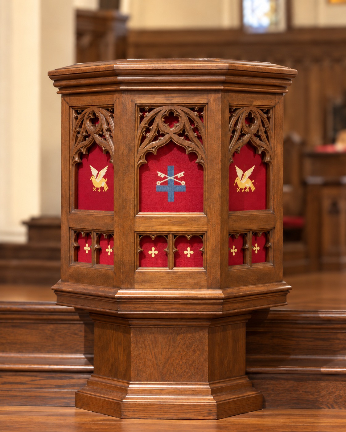 Enhanced portrait of St. Peter’s carved wooden pulpit, with red needlework panels, St. Peter’s inverted cross and keys, and a wooden pedestal.